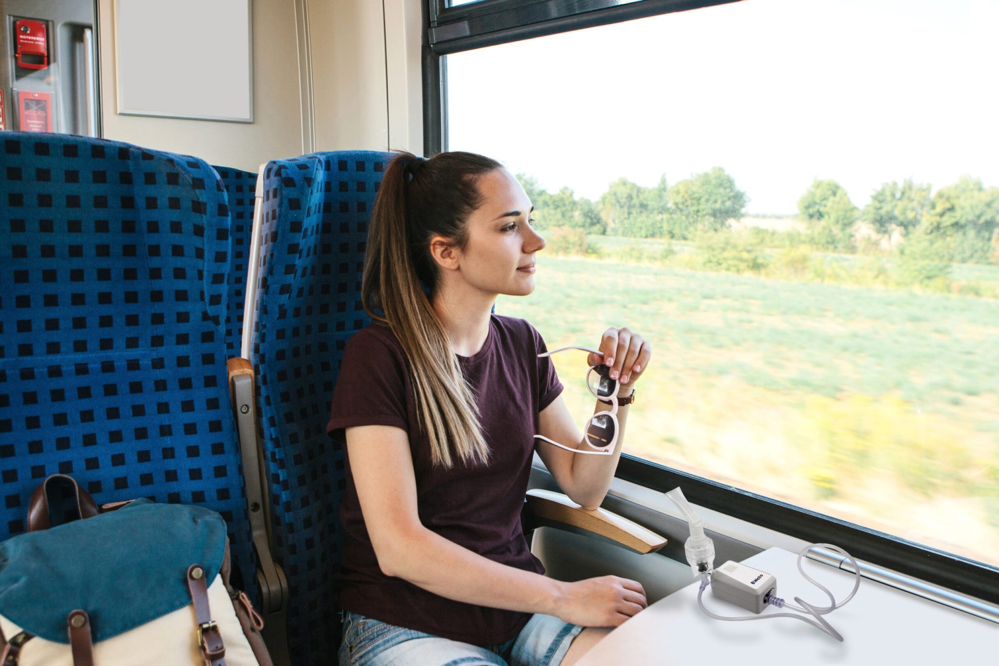 Young beautiful girl tourist travels by train