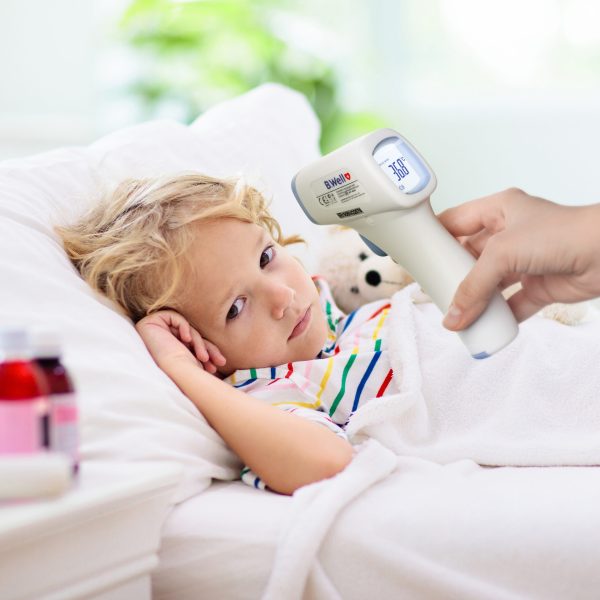 Sick little boy with asthma medicine. Ill child.