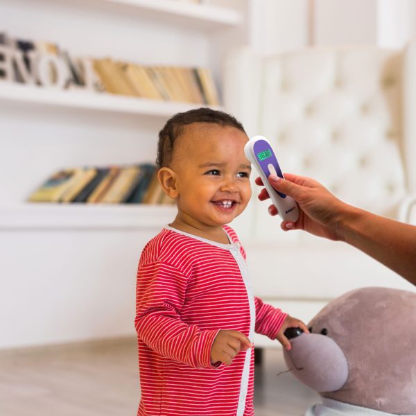 Happy baby boy playing with his teddy bear